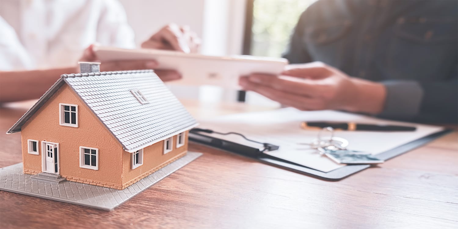 Couple reviewing property tax forms - tax default concept